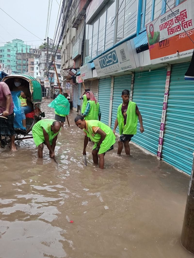 City corporation workers clear drains in Merul Badda area on 12 July 2024